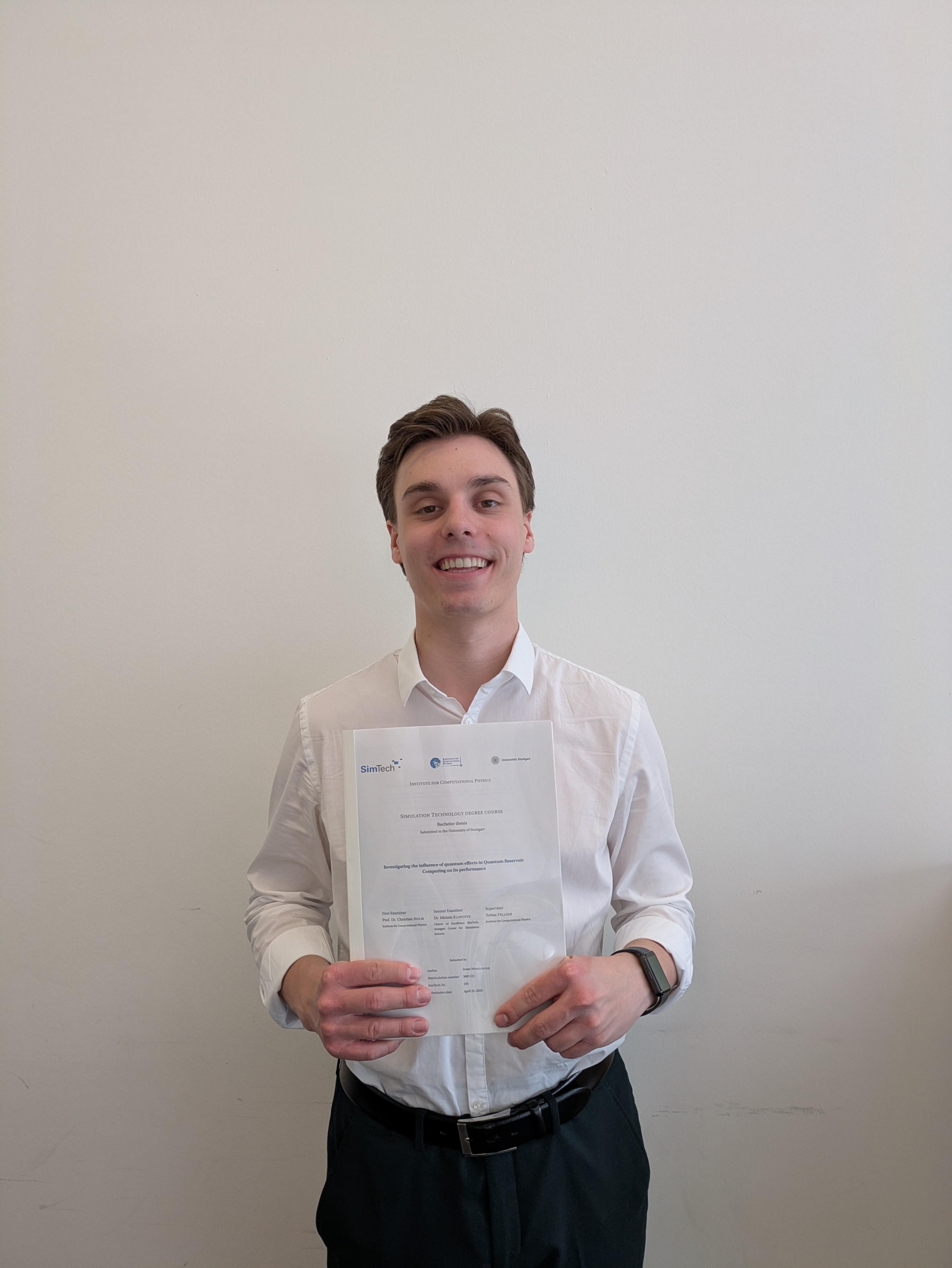 Jonas Merklinger smiling while showing his BSc thesis